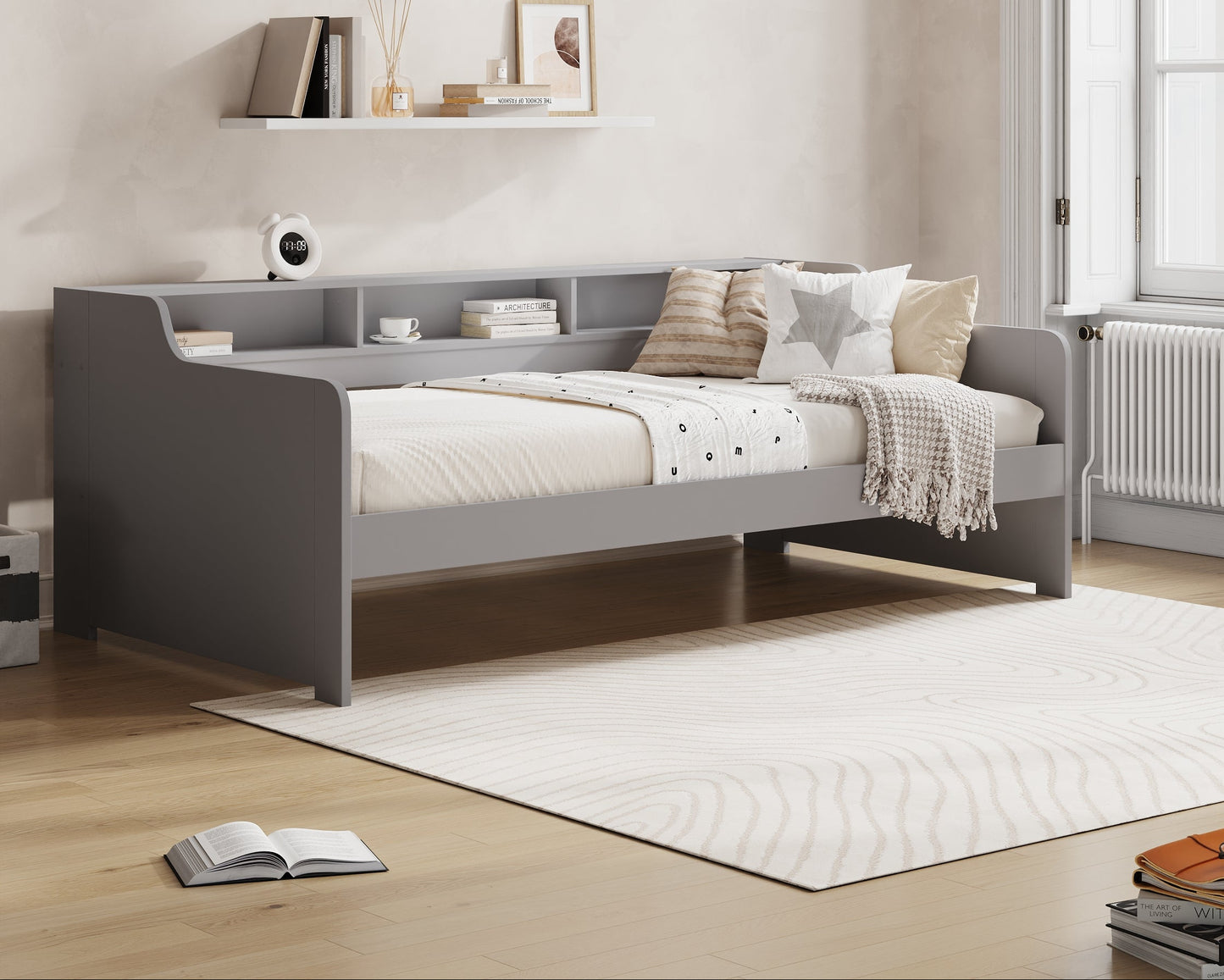 Gray bed in a room with 'Millie & Jones' branding on the wall.