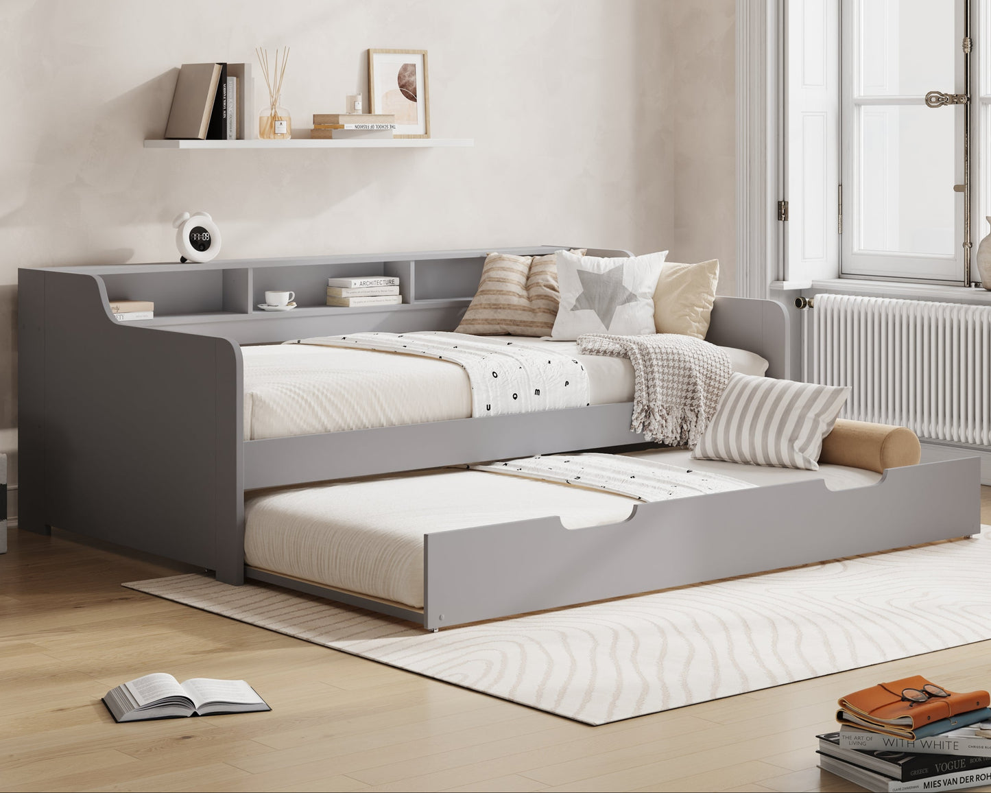 Gray bed with storage drawers in a room with 'Millie & Jones' branding.