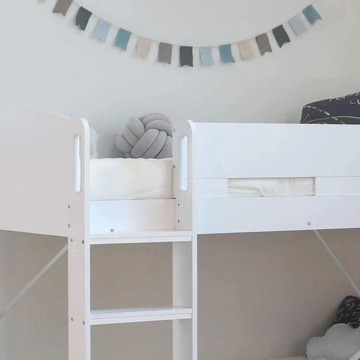 Top bunk of the Ripley Bunk Bed in white, with the ladder and the hand-holds in the end panel