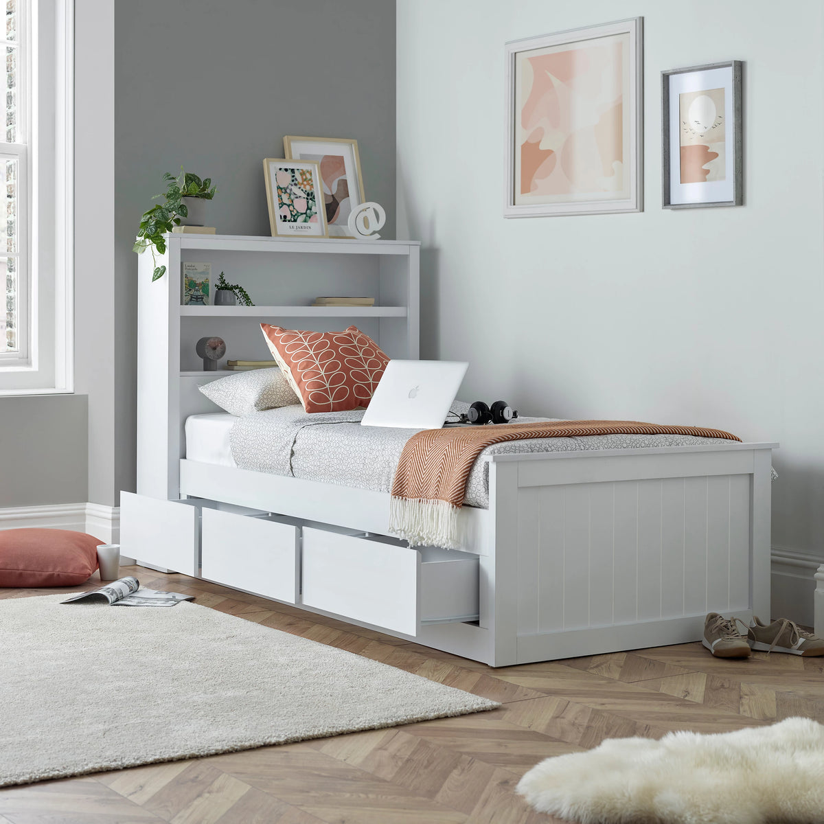 White Enzo single storage bed with three drawers and bookshelves in the headboard