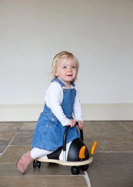 Toddler riding the Wheelybug Cow