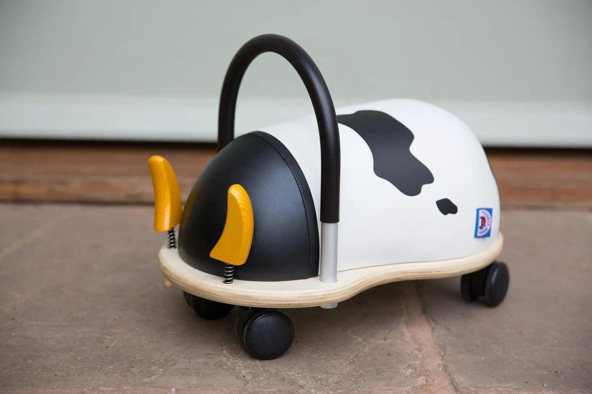 Wheelybug Cow ride-on toy indoors