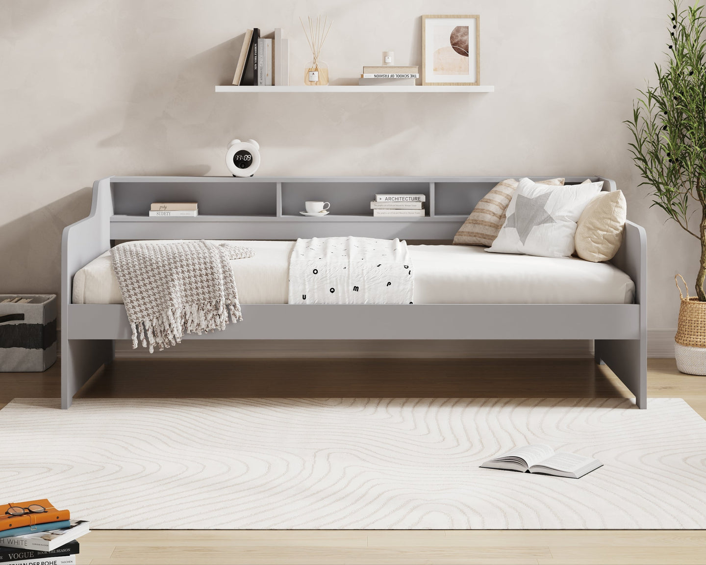 Gray daybed with white bedding and pillows in a room with 'Millie & Jones' branding.