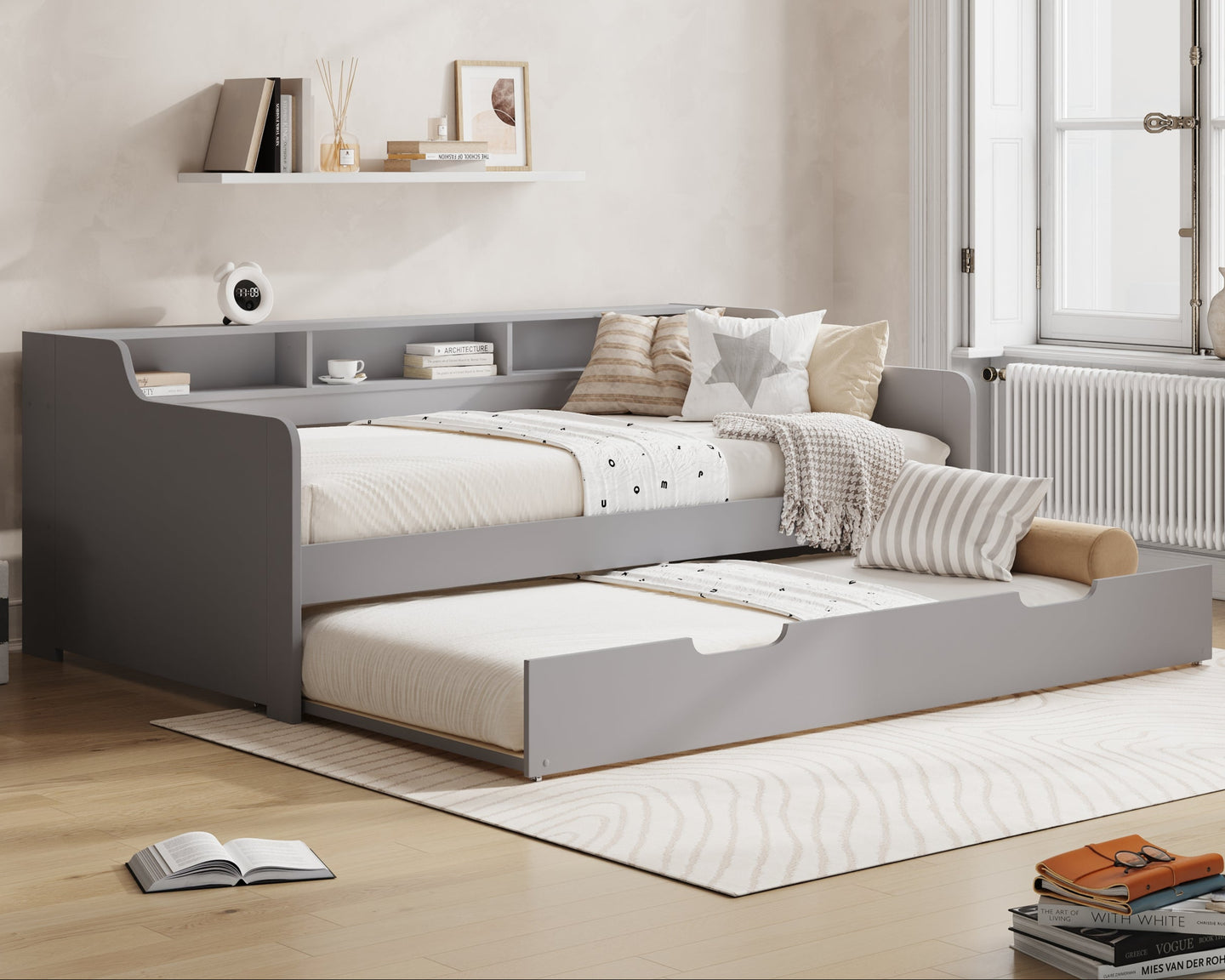 Gray bed with storage drawers in a room with 'Millie & Jones' branding.
