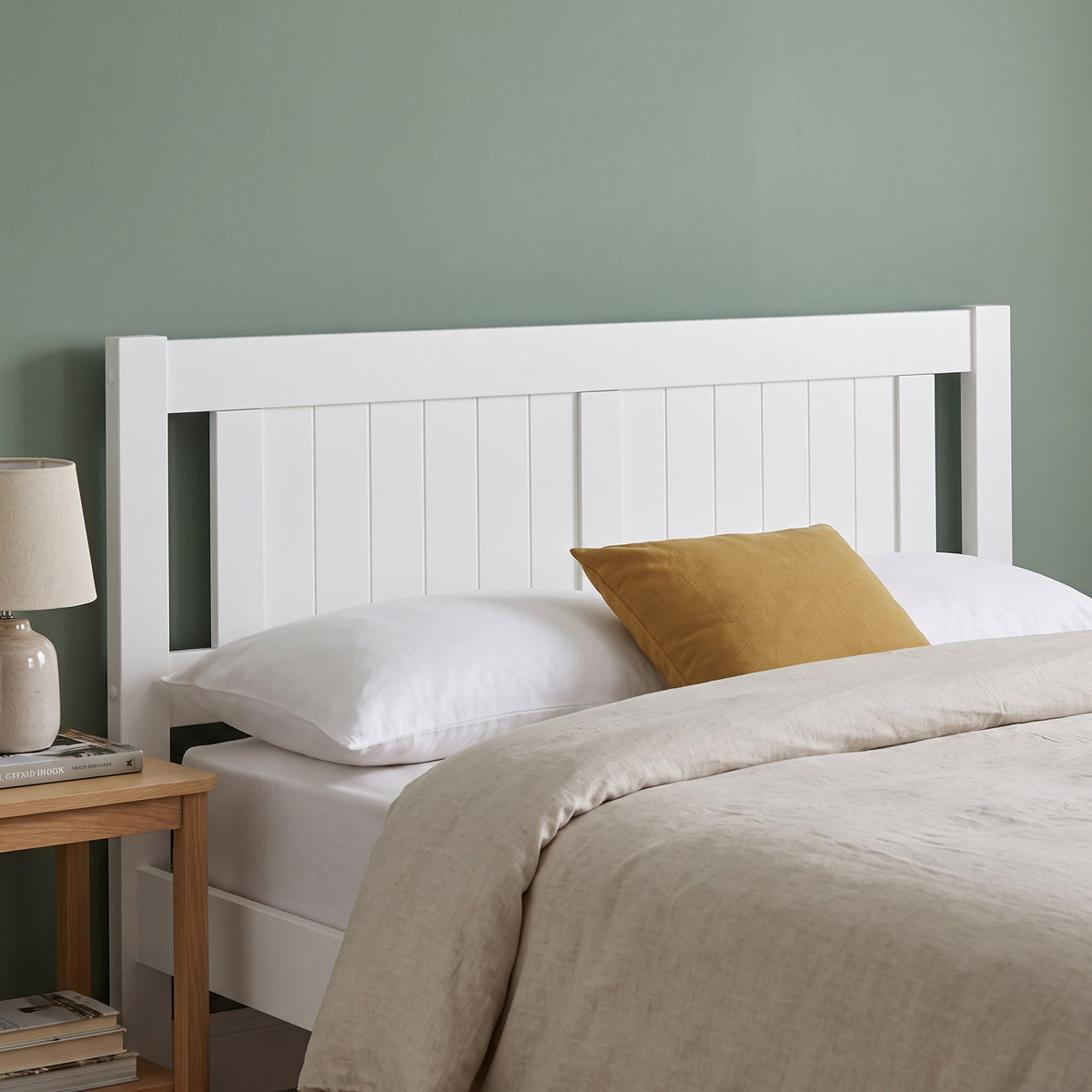 Close-up of the Elysian headboard: white tongue and groove panel between two square posts, with an open slot at each side