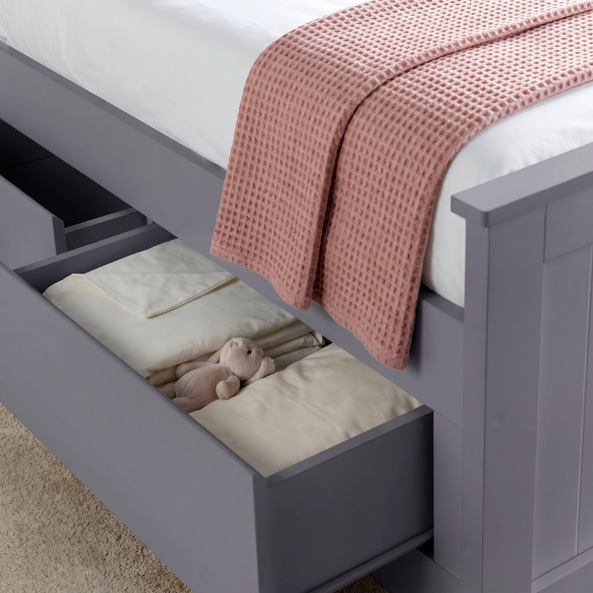 Hartley grey bed drawer pulled open with folded bedding inside