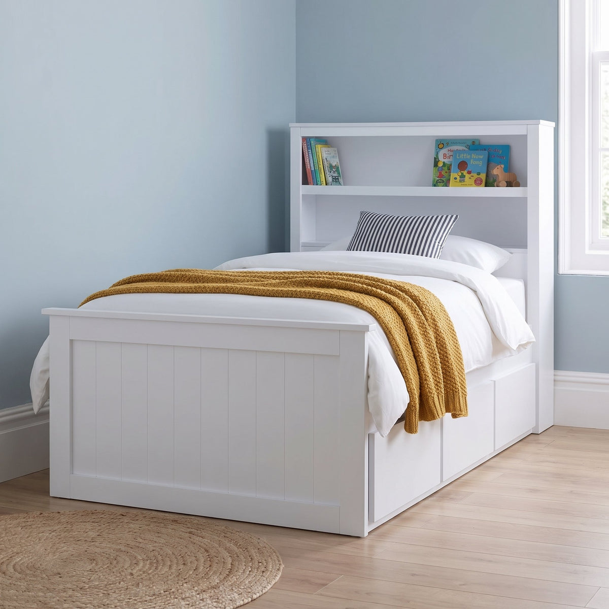 Hartley white bookcase storage bed seen from the foot end, showing the panelled footboard