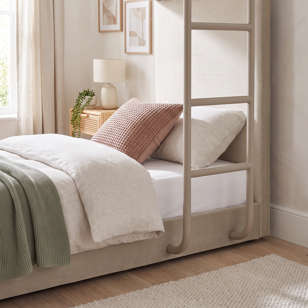 Close-up of the bottom bunk and curved ladder feet on the taupe Hadleigh bunk bed