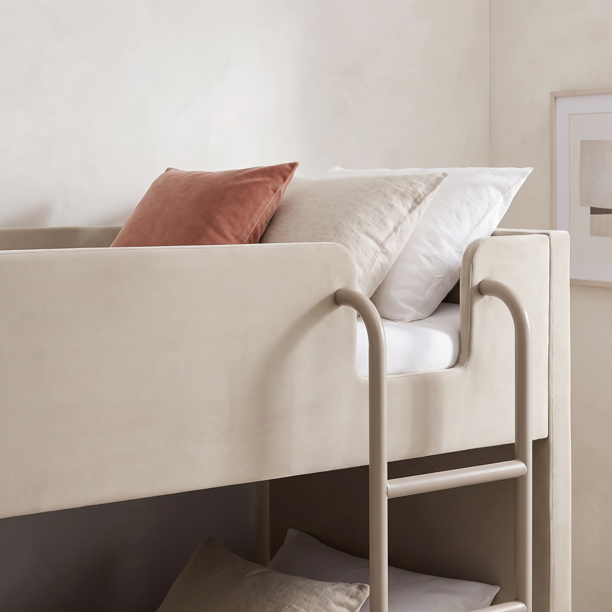 Close-up of the curved metal ladder hooking over the taupe velvet guard rail