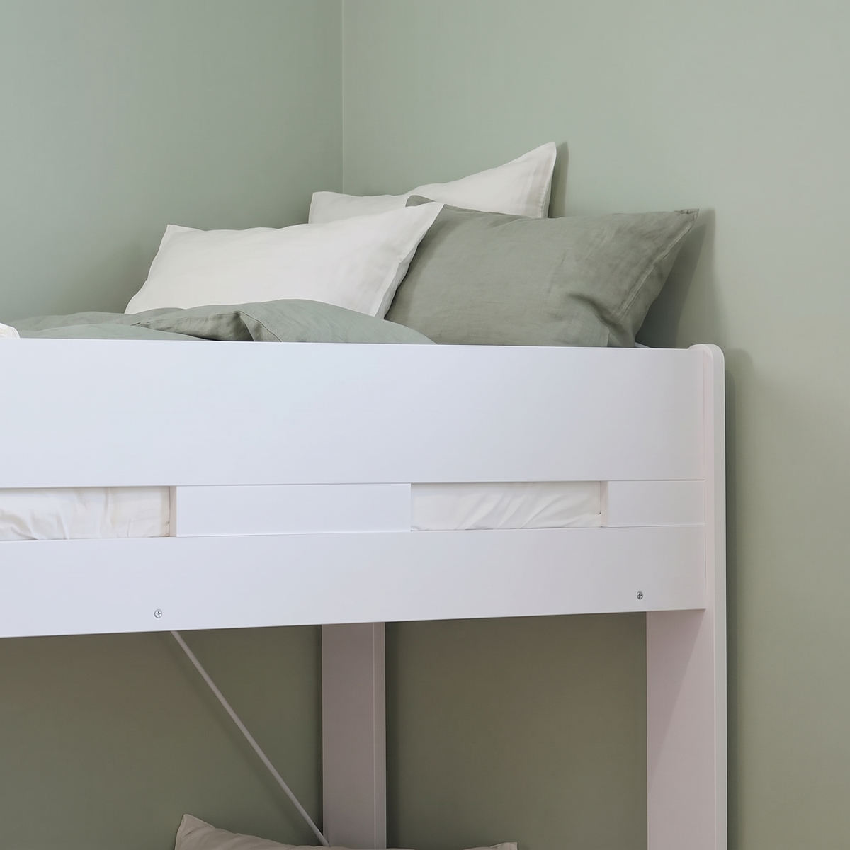 Safety guard rail around the top bunk of the white Ripley bunk bed