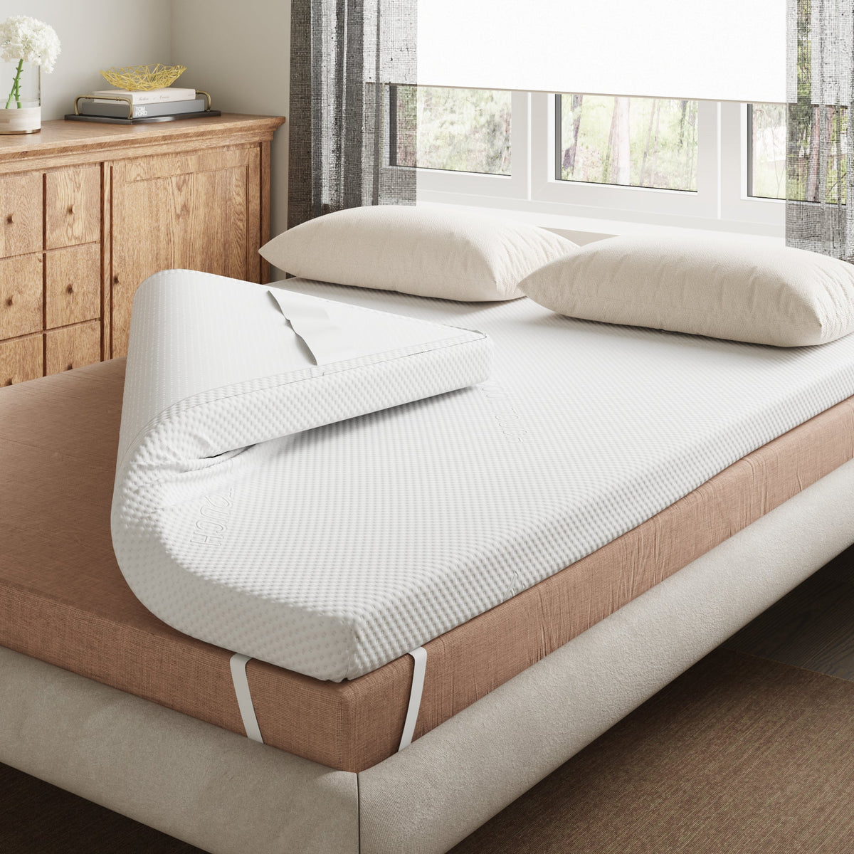 Millie & Jones 2.5cm Memory Foam Mattress Topper on a bed, with one corner folded back